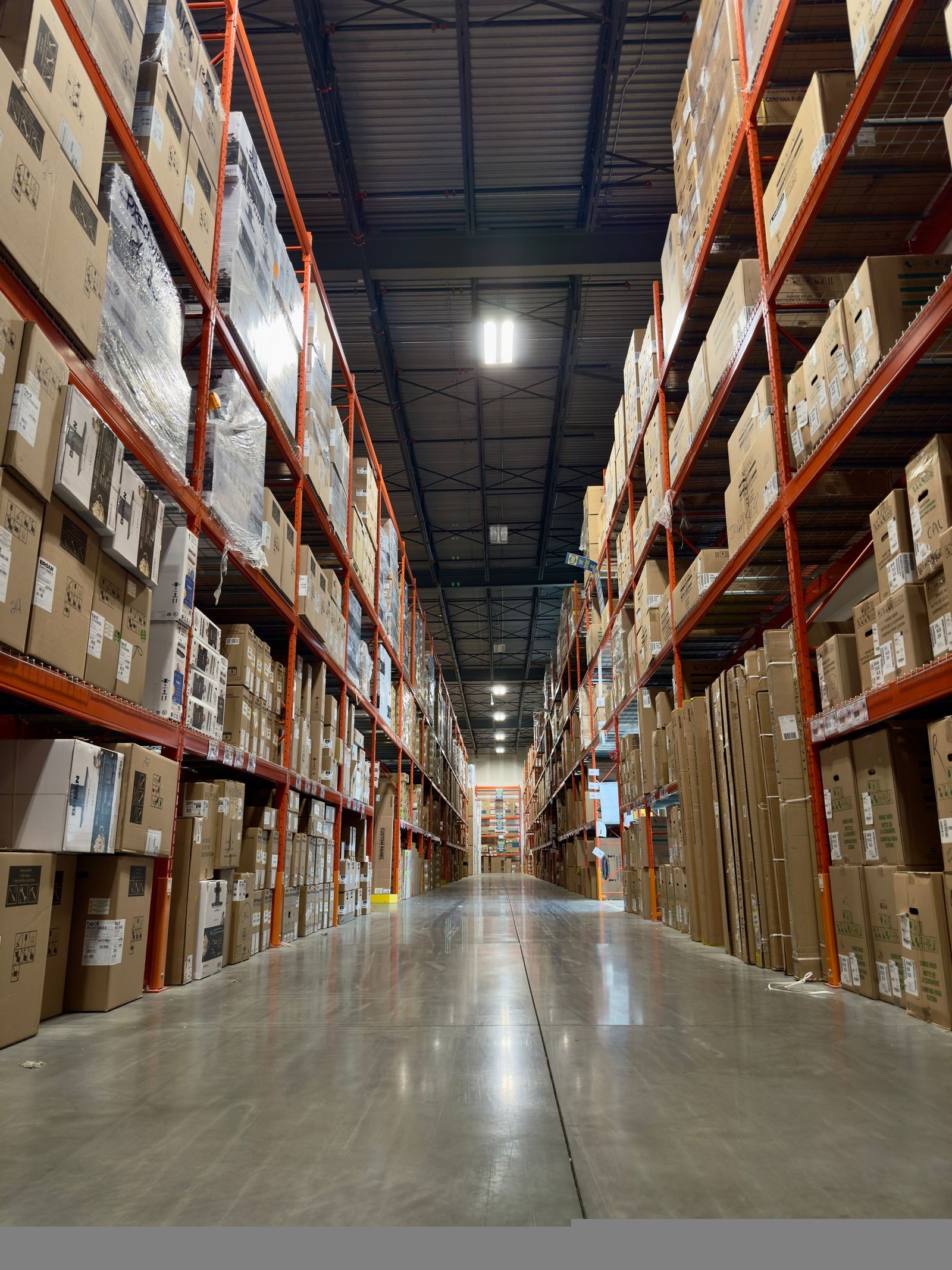 Tall warehouse aisle stocked with boxed merchandise